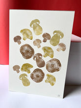 Load image into Gallery viewer, A white piece of paper with brown mushrooms printed onto it
