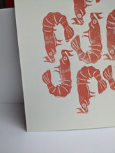 Load image into Gallery viewer, A white print with seven peach coloured shrimp designs printed on it against an orange background

