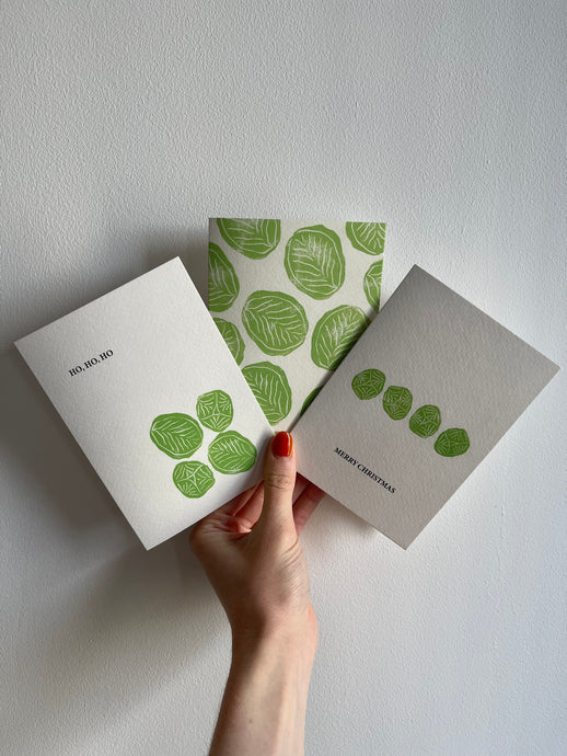 A trio of card printed with green brussels sprouts on the front