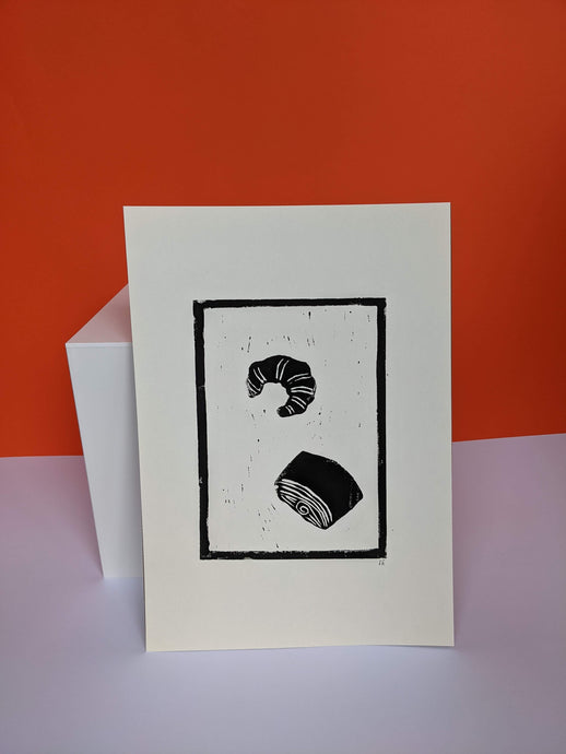 Black and white croissant print on an orange background