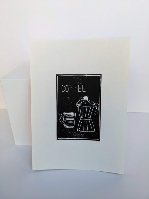 A black print of a cup of coffee and French press