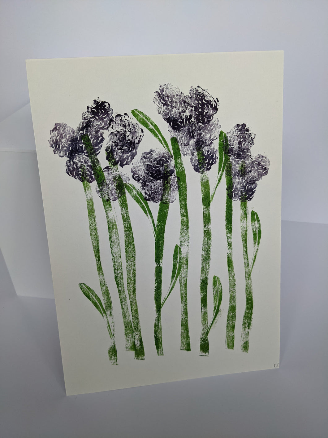 A white print with purple sprouting broccoli printed onto it