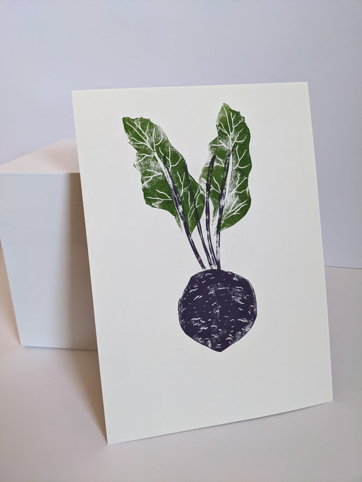 A purple beetroot print with green leaves