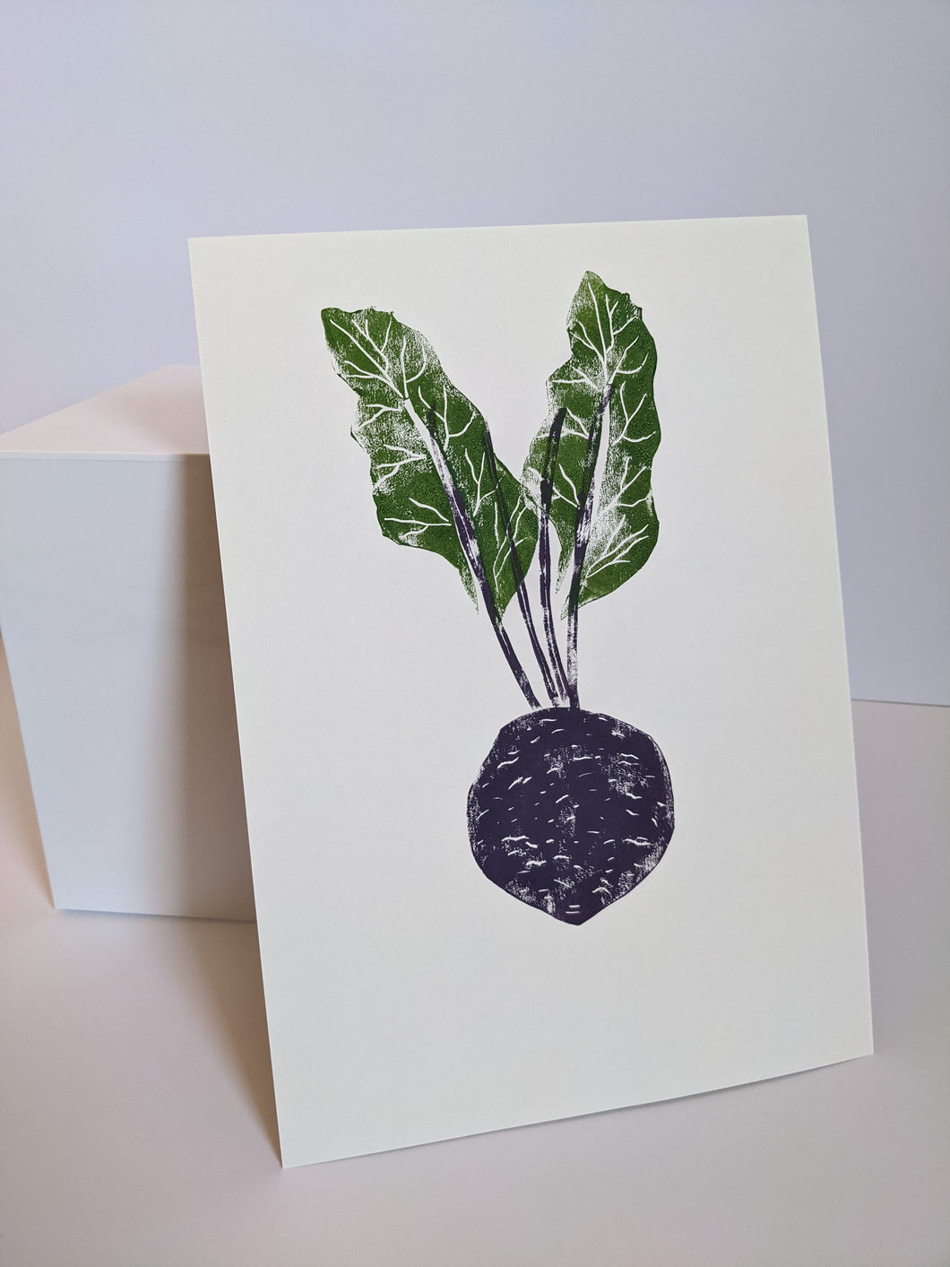 A purple beetroot print with green leaves