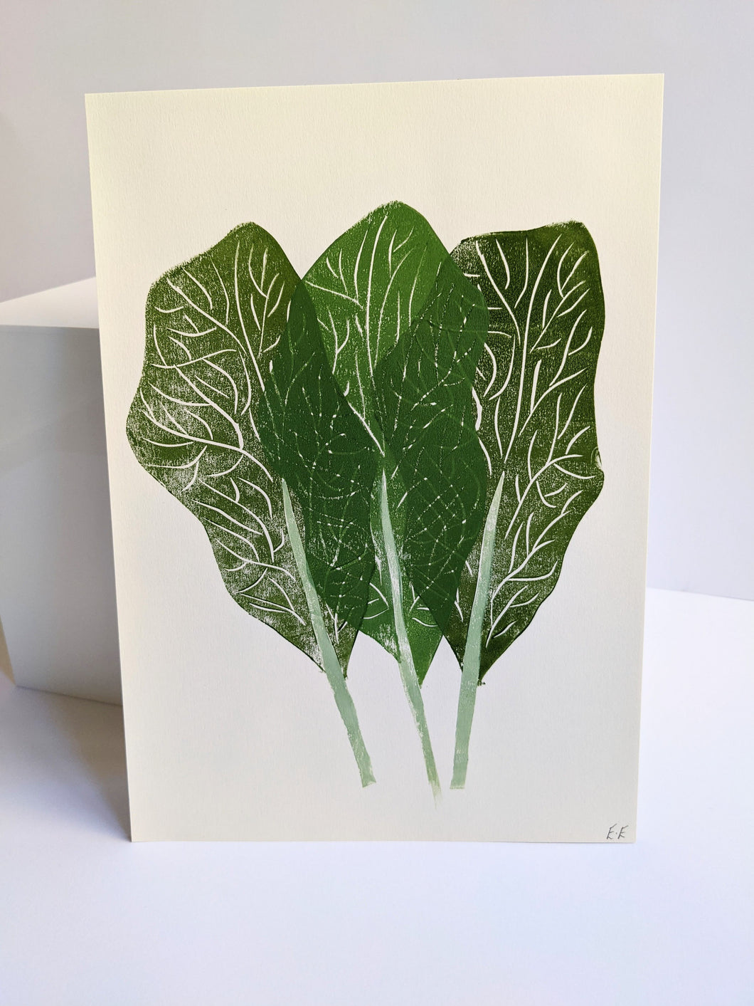 A print of three green leaves against a white background