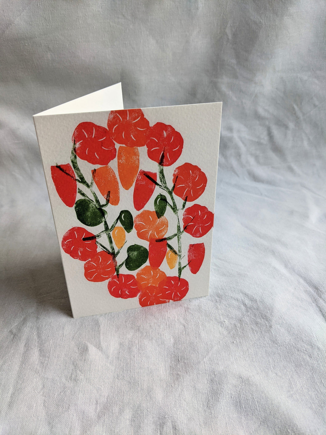 A white card with colourful tomatoes printed on the front