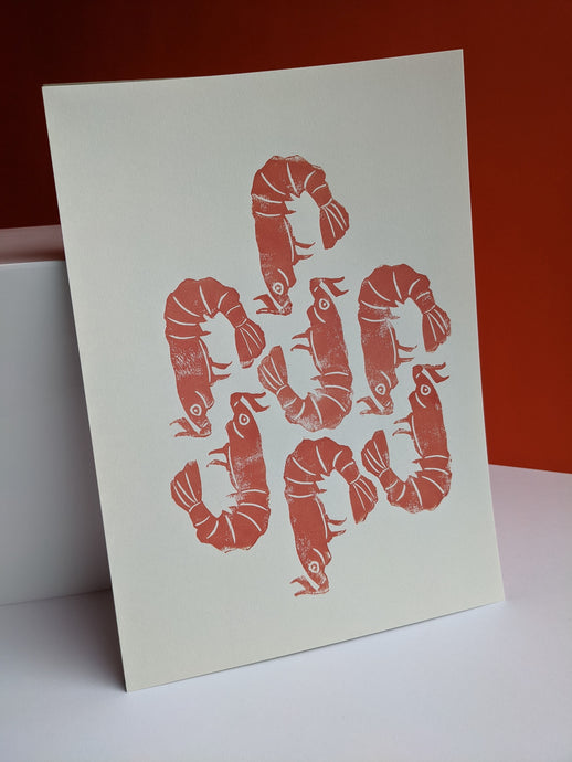 A white print with seven peach coloured shrimp designs printed on it against an orange background