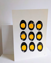 Load image into Gallery viewer, A white print with 9 black and yellow boiled eggs printed on
