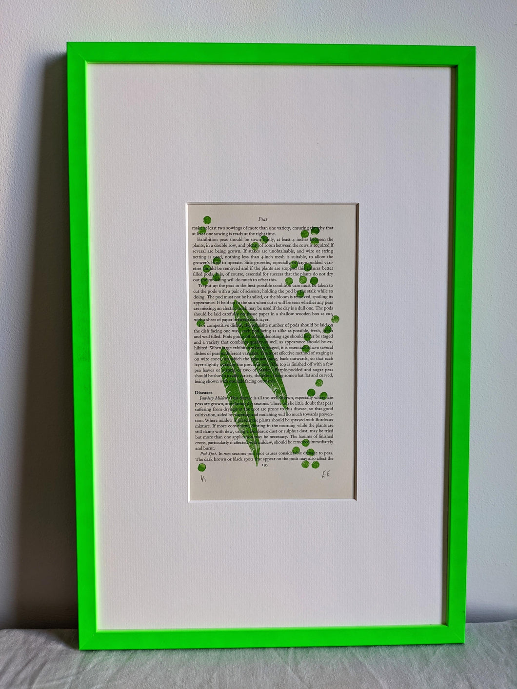 A slim green frame filled with a green pea pod print