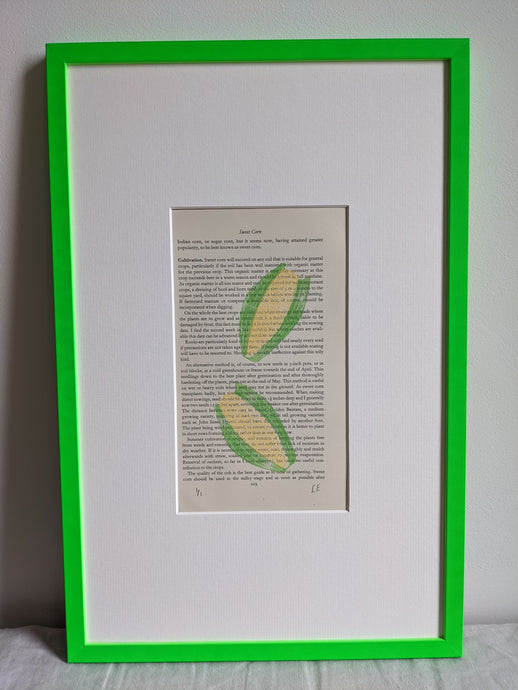 A slim green frame with a corn on the cob print inside