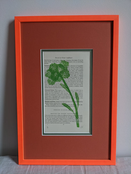 An orange frame with a broccoli print on the inside