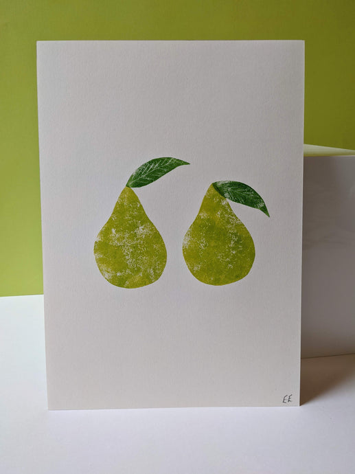 A white piece of paper with green green pears printed onto it